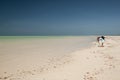 A photographer with a tripod on a deserted tropical beach Royalty Free Stock Photo
