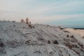 Photographer with a tripod shoots a landscape from the mountain. Phosphate gypsum waste from factories, creating artificial white