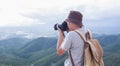 Photographer using Camera DSLR, Digital Single Lens Reflex take a photo Mountain and blue sky. Traveling Concept. Hiker concept