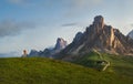 A photographer using a camera making a Beautiful early morning Dolomites Alps mountain landscape photo. Giau Pass or Passo di Giau