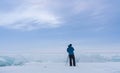 Photographer using camera tripod taking landscape photography in bad weather with overcast sky in the morning