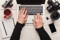 Photographer using laptop on workplace