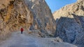 Photographer walking along Dark Canyon in Town of Kemaliye or Egin in Erzincan, Turkey