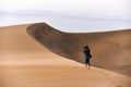 Photographer walking in the desert of gran canaria, spain Royalty Free Stock Photo