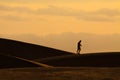 Photographer walking on sand dunes in Maspalomas Royalty Free Stock Photo