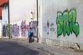 Photographer walks along graffiti walls in the Old town of Vilnius, Lithuania