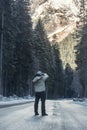 Photographer walks down a road in the winter with his camera. Royalty Free Stock Photo