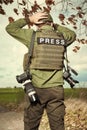 War photographer in conflict zone preparing for job