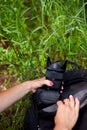 Photographer woman pack or takes out her camera backpack