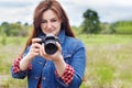 Photographer woman takes pictures with a camera