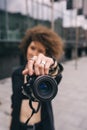 Photographer woman taking a photo with digital 50mm lens reflex camera