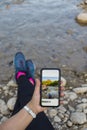 Photographer woman taking photos in nature with cell phone Royalty Free Stock Photo