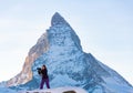 Photographer woman taking pictures of Swiss Alps against Matterhorn peak Royalty Free Stock Photo