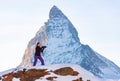 Photographer woman taking pictures of Swiss Alps against Matterhorn peak Royalty Free Stock Photo