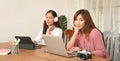 Photographer Women are working together with a computer tablet and laptop at the wooden working desk Royalty Free Stock Photo