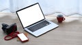 Photographer work place with  notebook, smartphone, camera and coffee cup on wooden floor. Royalty Free Stock Photo