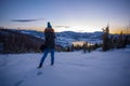 Photographers photographing winter lake mountain scene in sunset, alone in wilderness