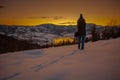 Photographers photographing winter lake mountain scene in sunset, alone in wilderness