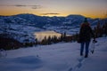 Photographers photographing winter lake mountain scene in sunset, alone in wilderness