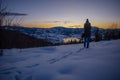 Photographers photographing winter lake mountain scene in sunset, alone in wilderness