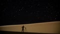 Photographers shadow on a sand dune at night Royalty Free Stock Photo