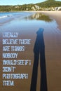 Photographers shadow stretches out impossibly long on wet sand as she takes a picture with quote I really believe there are thing Royalty Free Stock Photo