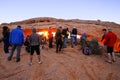 Photographers and tourists watching sunrise at Mesa Arch, Canyo