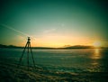 Photographers tripod ready to takes picture of frozen river