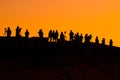 Photographers under orange sunset sky Royalty Free Stock Photo