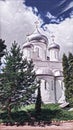 Photographic art picture of white towers of famous Nikitsky orthodox monastery under blue cloudy sky in summer