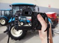 Photographic camera and blue agricultural tractor