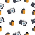 Photographic film in a reel and a camera on a white background Royalty Free Stock Photo