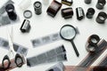 Photographic films, scissors and magnifying glass on white background