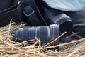 Photographic lens is lying on a haystack, countryside protographer concept