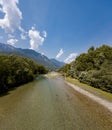 Photographic shot of the Ticino river from the Monte Carasso footbridge. River sky and nature