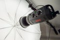 Photographic studio strobe lighting and reflective umbrella Royalty Free Stock Photo