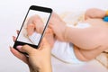 Photographing baby concept - feet of a six months old baby wearing diapers Royalty Free Stock Photo