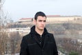 Photographing Danila MaziÃâ¡ with a black coat and black pants a background Petrovaradin fortress and the Danube