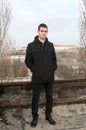 Photographing Danila MaziÃâ¡ with a black coat and black pants a background Petrovaradin fortress and the Danube