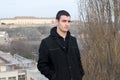 Photographing Danila MaziÃâ¡ with a black coat and black pants a background Petrovaradin fortress and the Danube