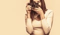 Photographing girl joy make photography taking concept. Girl with a cameras. Woman holding camera over gray background Royalty Free Stock Photo