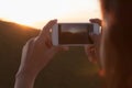 photographing sunset with Smart phone camera Royalty Free Stock Photo