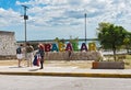Photographing tourists in front of the colored lettering bacalar, quintana roo, mexico