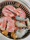 a photography of a basket of shrimp and shrimp meat on a grill, plate of shrimp, bacon, and shrimp on a grill