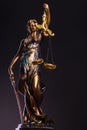 Photography of bronze themis sculpture, femida or justice goddess on dark background