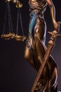 Photography of bronze themis sculpture, femida or justice goddess on dark background