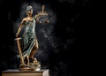 Photography of bronze themis sculpture, femida or justice goddess on dark background