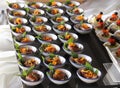 a photography of a buffet with a variety of appetizers and small bowls of food