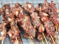 a photography of a bunch of meat skewered on a grill, a close up of a bunch of meat on a grill