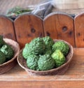 a photography of a couple of baskets of green fruit on a table